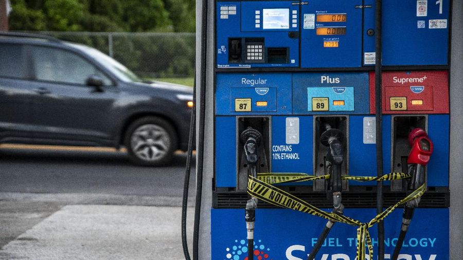 Customers fill up their automobiles and gas containers with fuel at the Circle K on Wednesday, May 12, 2021 in Raleigh, N.C.  Several gas stations in the Southeast reported running out of fuel, primarily because of what analysts say is unwarranted panic-buying among drivers, as the shutdown of a major pipeline by hackers entered its fifth day.  (Robert Willett/The News & Observer via AP)