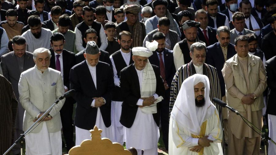 Afghanistan's President Ashraf Ghani, center, attends an Eid al-Fitr prayer at the presidential palace in Kabul, Afghanistan, Thursday, May 13, 2021. Eid al-Fitr prayer marks the end of the holy fasting month of Ramadan in Afghanistan. (AP Photo/Mariam Zuhaib)