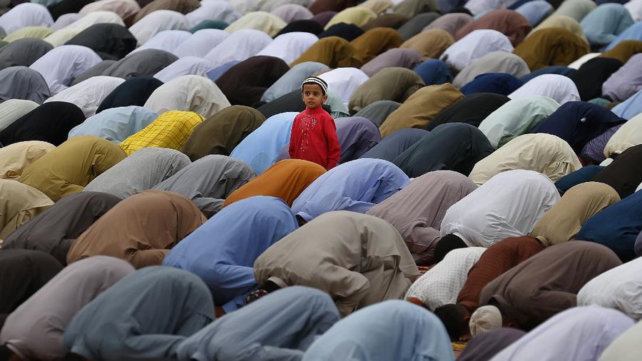 Muslims offer prayers during the first day of Eid al-Fitr, which marks the end of the holy month of Ramadan at Fatih Mosque in Istanbul, Thursday, May 13, 2021. Hundreds of Muslims attended dawn Eid al-Fitr prayers Thursday marking the end of a month of prayer and fasting for Muslims around the world, a usually joyous three-day celebration that has been significantly toned down as coronavirus cases soar. (AP Photo/Emrah Gurel)