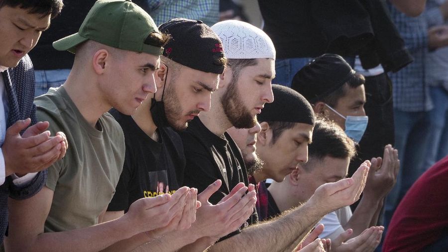 Muslims offer prayers during the first day of Eid al-Fitr, which marks the end of the holy month of Ramadan at Fatih Mosque in Istanbul, Thursday, May 13, 2021. Hundreds of Muslims attended dawn Eid al-Fitr prayers Thursday marking the end of a month of prayer and fasting for Muslims around the world, a usually joyous three-day celebration that has been significantly toned down as coronavirus cases soar. (AP Photo/Emrah Gurel)