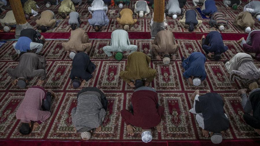 Muslims offer prayers during the first day of Eid al-Fitr, which marks the end of the holy month of Ramadan at Fatih Mosque in Istanbul, Thursday, May 13, 2021. Hundreds of Muslims attended dawn Eid al-Fitr prayers Thursday marking the end of a month of prayer and fasting for Muslims around the world, a usually joyous three-day celebration that has been significantly toned down as coronavirus cases soar. (AP Photo/Emrah Gurel)
