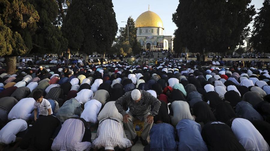 Muslims take part in Eid al-Fitr prayers at the Dome of the Rock Mosque in the Al-Aqsa Mosque compound in the Old City of Jerusalem, Thursday, May 13, 2021. Eid al-Fitr, festival of breaking of the fast, marks the end of the holy month of Ramadan. (AP Photo/Mahmoud Illean)