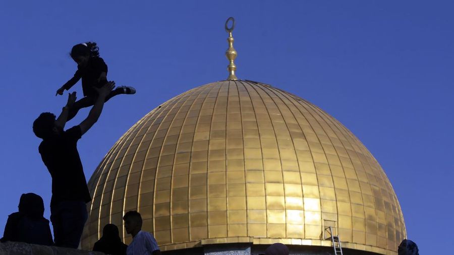 Muslims take part in Eid al-Fitr prayers at the Dome of the Rock Mosque in the Al-Aqsa Mosque compound in the Old City of Jerusalem, Thursday, May 13, 2021. Eid al-Fitr, festival of breaking of the fast, marks the end of the holy month of Ramadan. (AP Photo/Mahmoud Illean)