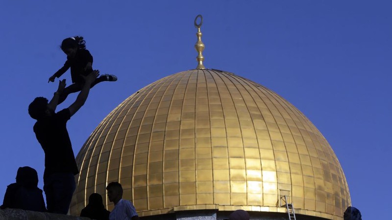 Muslims take part in Eid al-Fitr prayers at the Dome of the Rock Mosque in the Al-Aqsa Mosque compound in the Old City of Jerusalem, Thursday, May 13, 2021. Eid al-Fitr, festival of breaking of the fast, marks the end of the holy month of Ramadan. (AP Photo/Mahmoud Illean)