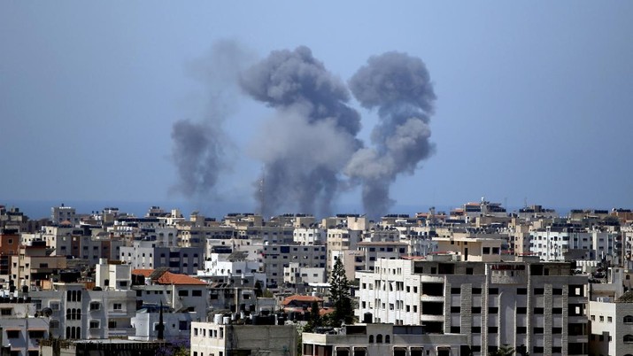 Smoke rises following Israeli airstrikes on a building in Gaza City, Thursday, May 13, 2021. Israeli airstrikes killed multiple senior Hamas military figures Wednesday and toppled a pair of high-rise towers housing Hamas facilities. (AP Photo/Hatem Moussa)