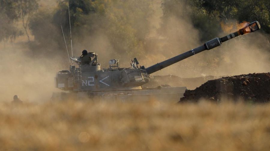 An Israeli artillery unit fires toward targets in Gaza Strip, at the Israeli Gaza border, Thursday, May 13, 2021. (AP Photo/Ariel Schalit)