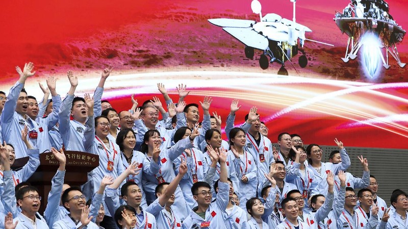In this photo released by Xinhua News Agency, members at the Beijing Aerospace Control Center celebrate after China's Tianwen-1 probe successfully landed on Mars, at the center in Beijing, Saturday, May 15, 2021. China landed a spacecraft on Mars for the first time on Saturday, a technically challenging feat more difficult than a moon landing, in the latest advance for its ambitious goals in space. (Jin Liwang/Xinhua via AP)