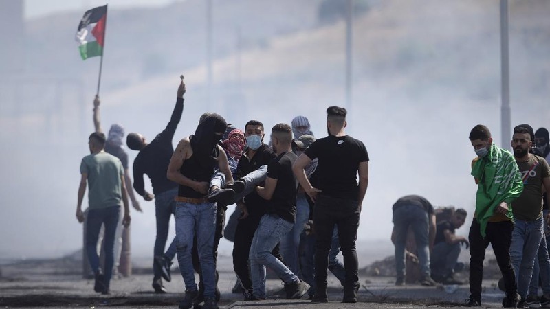 Israeli police deploy a water cannon to disperse protesters in the Sheikh Jarrah neighborhood of east Jerusalem, where several Palestinian families are under imminent threat of forcible eviction from their homes, Friday, May 14, 2021. (AP Photo/ Mahmoud Illean)