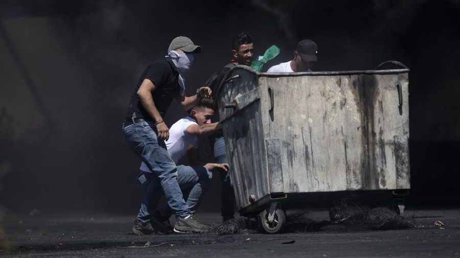 Israeli police deploy a water cannon to disperse protesters in the Sheikh Jarrah neighborhood of east Jerusalem, where several Palestinian families are under imminent threat of forcible eviction from their homes, Friday, May 14, 2021. (AP Photo/ Mahmoud Illean)