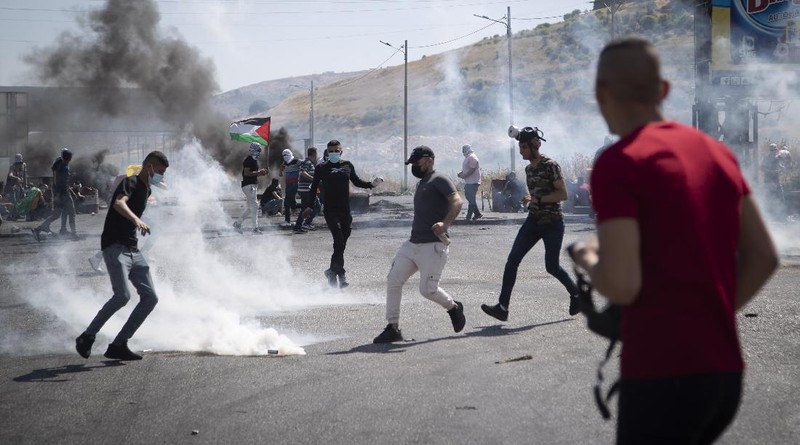 Israeli police deploy a water cannon to disperse protesters in the Sheikh Jarrah neighborhood of east Jerusalem, where several Palestinian families are under imminent threat of forcible eviction from their homes, Friday, May 14, 2021. (AP Photo/ Mahmoud Illean)
