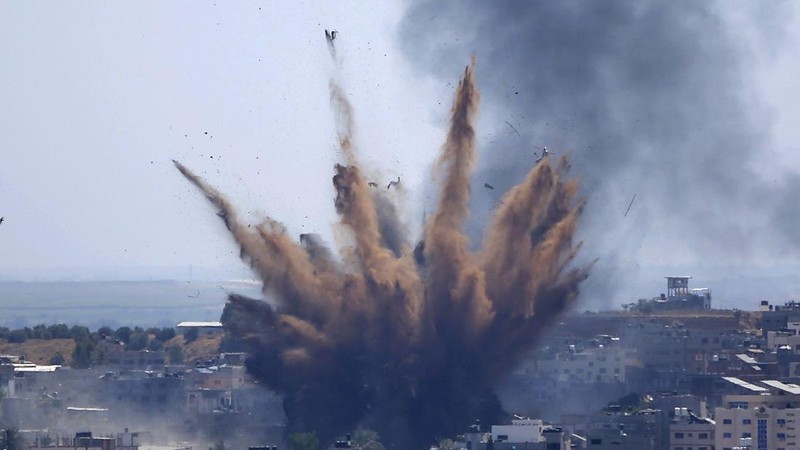 Smoke rises following Israeli airstrikes on a building in Gaza City, Thursday, May 13, 2021. Weary Palestinians are somberly marking the end of the Muslim holy month of Ramadan, as Hamas and Israel traded more rockets and airstrikes and Jewish-Arab violence raged across Israel. (AP Photo/Hatem Moussa)