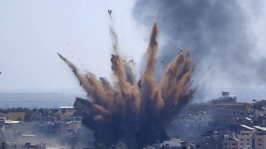 Smoke rises following Israeli airstrikes on a building in Gaza City, Thursday, May 13, 2021. Weary Palestinians are somberly marking the end of the Muslim holy month of Ramadan, as Hamas and Israel traded more rockets and airstrikes and Jewish-Arab violence raged across Israel. (AP Photo/Hatem Moussa)