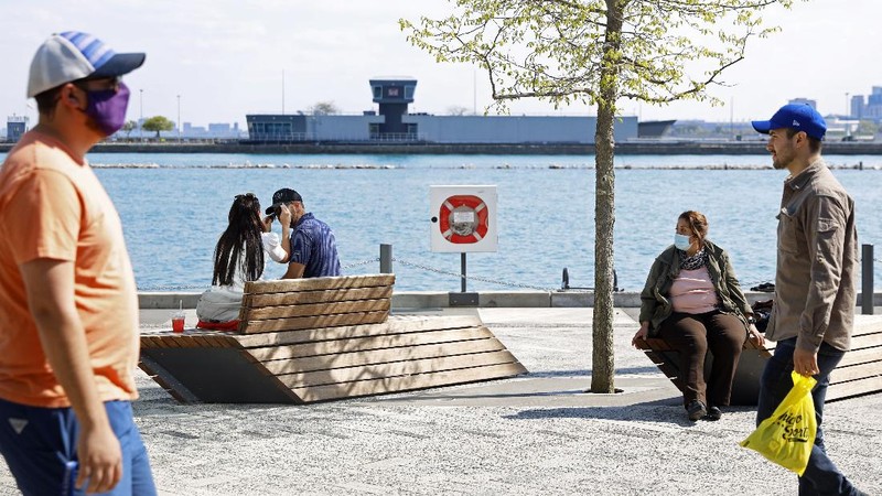 People enjoy their time in a wave swinger Friday, May 14, 2021 at Chicago's Navy Pier. The U.S. Centers for Disease Control and Prevention eased its guidelines, saying fully vaccinated people can resume activities without wearing masks. (AP Photo/Shafkat Anowar)