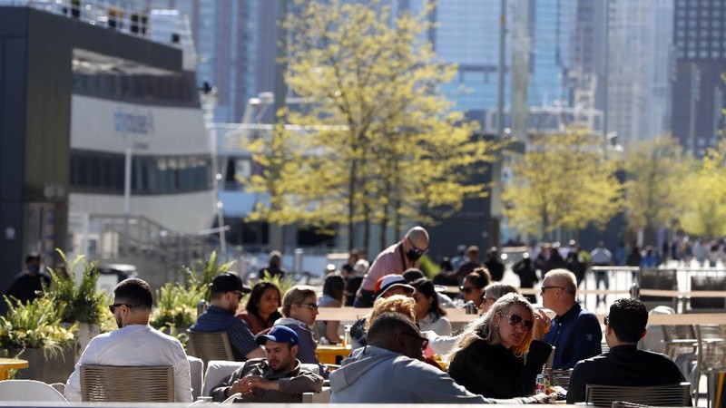 People enjoy their time in a wave swinger Friday, May 14, 2021 at Chicago's Navy Pier. The U.S. Centers for Disease Control and Prevention eased its guidelines, saying fully vaccinated people can resume activities without wearing masks. (AP Photo/Shafkat Anowar)