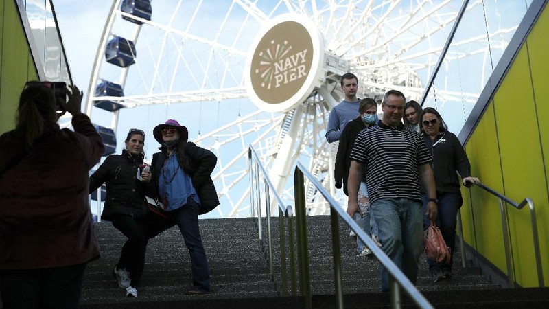 People enjoy their time in a wave swinger Friday, May 14, 2021 at Chicago's Navy Pier. The U.S. Centers for Disease Control and Prevention eased its guidelines, saying fully vaccinated people can resume activities without wearing masks. (AP Photo/Shafkat Anowar)