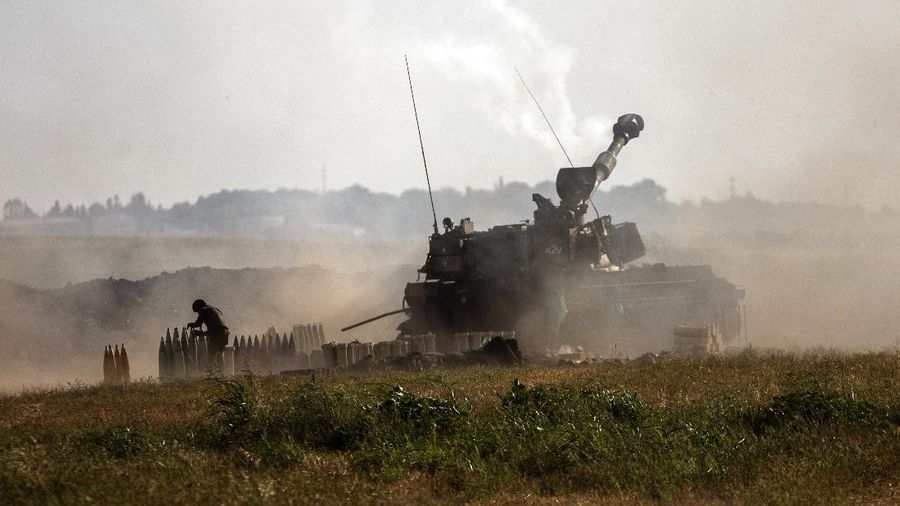 An Israeli artillery unit fires toward targets in the Gaza Strip, at the Israeli-Gaza border, Sunday, May 16, 2021. (AP Photo/Heidi Levine)