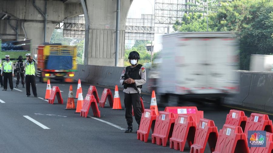 Petugas kepolisian berjaga di pos penyekatan arus balik lebaran di Tol Jakarta Cikampek KM 34B, Cikarang, Jawa Barat, Senin (17/5/2021). Direktorat Lalu Lintas (Ditlantas) Polda Metro Jaya serta sejumlah instansi terkait melakukan tes antigen secara gratis bagi pengendara yang belum memiliki surat bebas Covid-1 untuk kembali ke wilayah Jakarta dan Sekitarnya. Petugas gabungan terdiri dari TNI, Polri dan Satpol sebelumnya melakukan apel bersama, setidaknya ada 100 petugas gabungan yang ditugaskan dilokasi penyekatan. 
. (CNBC Indonesia/ Tri Susilo)