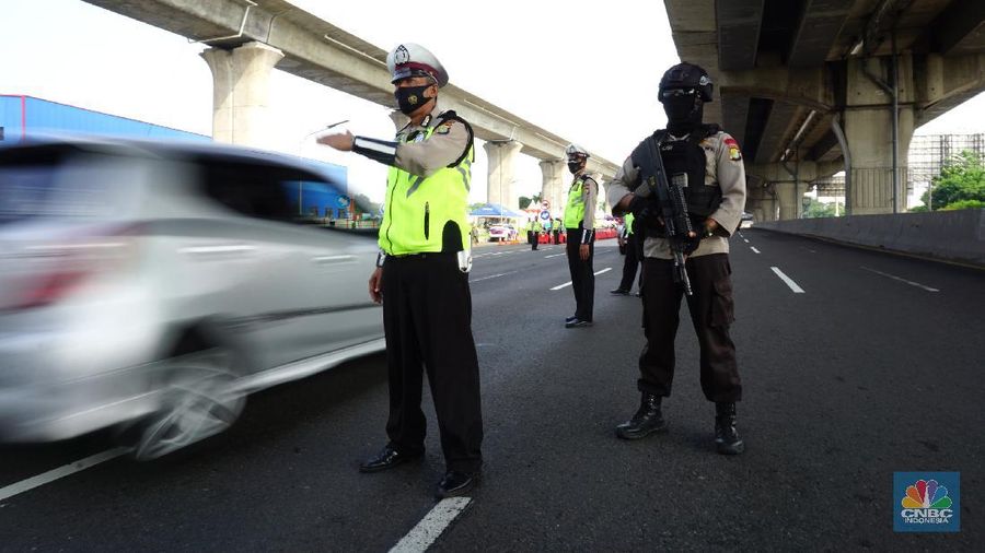 Petugas kepolisian berjaga di pos penyekatan arus balik lebaran di Tol Jakarta Cikampek KM 34B, Cikarang, Jawa Barat, Senin (17/5/2021). Direktorat Lalu Lintas (Ditlantas) Polda Metro Jaya serta sejumlah instansi terkait melakukan tes antigen secara gratis bagi pengendara yang belum memiliki surat bebas Covid-1 untuk kembali ke wilayah Jakarta dan Sekitarnya. Petugas gabungan terdiri dari TNI, Polri dan Satpol sebelumnya melakukan apel bersama, setidaknya ada 100 petugas gabungan yang ditugaskan dilokasi penyekatan. 
. (CNBC Indonesia/ Tri Susilo)