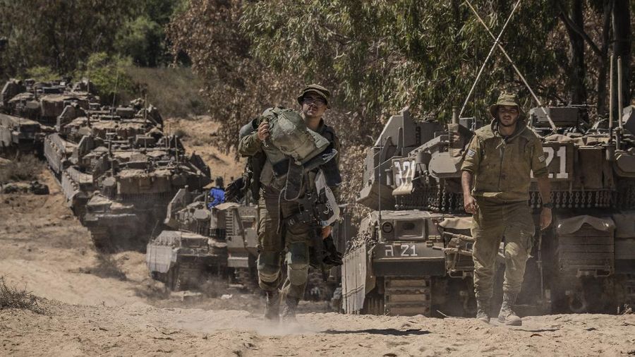 Israeli soldiers gather at a staging ground near the border with the Gaza Strip, in southern Israel, Sunday, May 16, 2021. (AP Photo/Tsafrir Abayov)