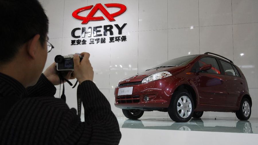 FILE - In this April 20, 2007 file photo, a man takes a picture of a car from Chinese automaker Chery during the Shanghai Auto Show in Shanghai, China.  India has the most transparent companies while Chinese firms are the most opaque, according to a global anti-graft watchdog’s survey released Monday, July 11, 2016, that assesses efforts by emerging market companies to fight corruption.  Thirty-seven Chinese companies were evaluated, making them the survey’s biggest group, but they had the weakest overall performance. The three companies that scored zero out of 10 were all Chinese, which includes automaker Chery. (AP Photo/Ng Han Guan, File)