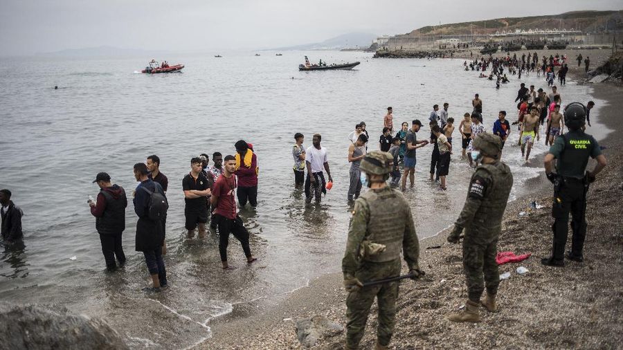 A migrant is rescued by a Spanish Civil guard boat near the border of Morocco and Spain, on Tuesday, May 18, 2021. Spain deployed its military to the Moroccan border Tuesday as thousands of migrants jumped fences or swam onto European soil for the second day in a row after Rabat loosened border controls amid a deepening diplomatic spat. Morocco's loosened border watch came after Spain decided to grant entry for medical treatment to the chief of a militant group that fights for the independence of Western Sahara. Morocco annexed the sprawling region on the west coast of Africa in 1975. (AP Photo/Bernat Armangue)