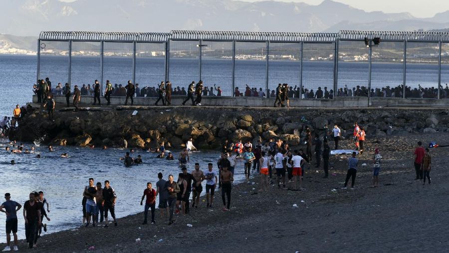 A migrant is rescued by a Spanish Civil guard boat near the border of Morocco and Spain, on Tuesday, May 18, 2021. Spain deployed its military to the Moroccan border Tuesday as thousands of migrants jumped fences or swam onto European soil for the second day in a row after Rabat loosened border controls amid a deepening diplomatic spat. Morocco's loosened border watch came after Spain decided to grant entry for medical treatment to the chief of a militant group that fights for the independence of Western Sahara. Morocco annexed the sprawling region on the west coast of Africa in 1975. (AP Photo/Bernat Armangue)