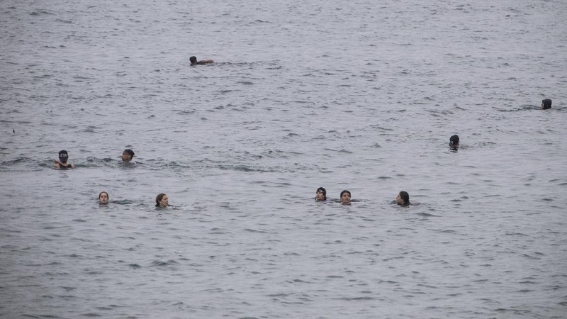 A migrant is rescued by a Spanish Civil guard boat near the border of Morocco and Spain, on Tuesday, May 18, 2021. Spain deployed its military to the Moroccan border Tuesday as thousands of migrants jumped fences or swam onto European soil for the second day in a row after Rabat loosened border controls amid a deepening diplomatic spat. Morocco's loosened border watch came after Spain decided to grant entry for medical treatment to the chief of a militant group that fights for the independence of Western Sahara. Morocco annexed the sprawling region on the west coast of Africa in 1975. (AP Photo/Bernat Armangue)