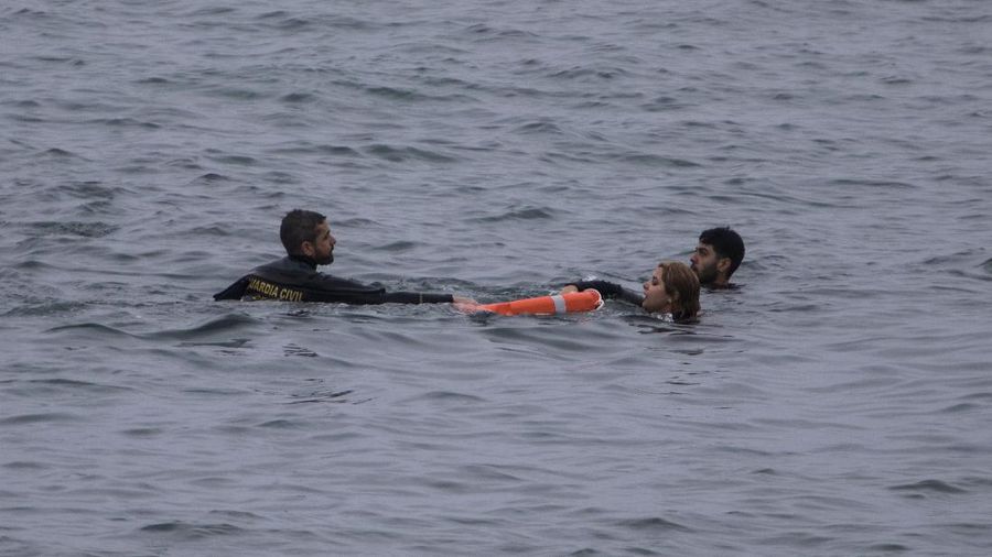 A migrant is rescued by a Spanish Civil guard boat near the border of Morocco and Spain, on Tuesday, May 18, 2021. Spain deployed its military to the Moroccan border Tuesday as thousands of migrants jumped fences or swam onto European soil for the second day in a row after Rabat loosened border controls amid a deepening diplomatic spat. Morocco's loosened border watch came after Spain decided to grant entry for medical treatment to the chief of a militant group that fights for the independence of Western Sahara. Morocco annexed the sprawling region on the west coast of Africa in 1975. (AP Photo/Bernat Armangue)