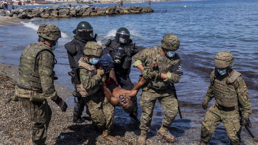 A migrant is rescued by a Spanish Civil guard boat near the border of Morocco and Spain, on Tuesday, May 18, 2021. Spain deployed its military to the Moroccan border Tuesday as thousands of migrants jumped fences or swam onto European soil for the second day in a row after Rabat loosened border controls amid a deepening diplomatic spat. Morocco's loosened border watch came after Spain decided to grant entry for medical treatment to the chief of a militant group that fights for the independence of Western Sahara. Morocco annexed the sprawling region on the west coast of Africa in 1975. (AP Photo/Bernat Armangue)