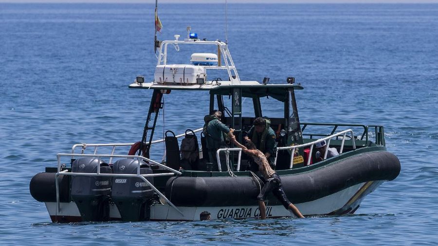 A migrant is rescued by a Spanish Civil guard boat near the border of Morocco and Spain, on Tuesday, May 18, 2021. Spain deployed its military to the Moroccan border Tuesday as thousands of migrants jumped fences or swam onto European soil for the second day in a row after Rabat loosened border controls amid a deepening diplomatic spat. Morocco's loosened border watch came after Spain decided to grant entry for medical treatment to the chief of a militant group that fights for the independence of Western Sahara. Morocco annexed the sprawling region on the west coast of Africa in 1975. (AP Photo/Bernat Armangue)