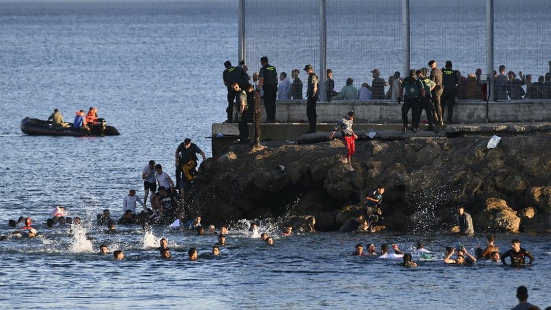 A migrant is rescued by a Spanish Civil guard boat near the border of Morocco and Spain, on Tuesday, May 18, 2021. Spain deployed its military to the Moroccan border Tuesday as thousands of migrants jumped fences or swam onto European soil for the second day in a row after Rabat loosened border controls amid a deepening diplomatic spat. Morocco's loosened border watch came after Spain decided to grant entry for medical treatment to the chief of a militant group that fights for the independence of Western Sahara. Morocco annexed the sprawling region on the west coast of Africa in 1975. (AP Photo/Bernat Armangue)