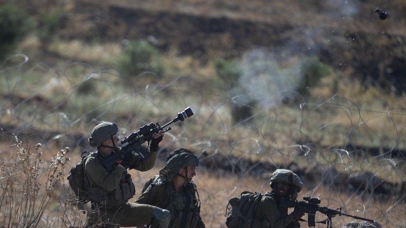 Palestinians clash with Israeli forces at the Hawara checkpoint, south of the West Bank city of Nablus, Tuesday, May 18, 2021. (AP Photo/Majdi Mohammed)