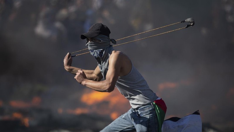 Palestinians clash with Israeli forces at the Hawara checkpoint, south of the West Bank city of Nablus, Tuesday, May 18, 2021. (AP Photo/Majdi Mohammed)