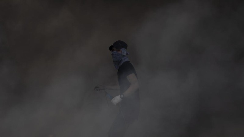 Palestinians clash with Israeli forces at the Hawara checkpoint, south of the West Bank city of Nablus, Tuesday, May 18, 2021. (AP Photo/Majdi Mohammed)