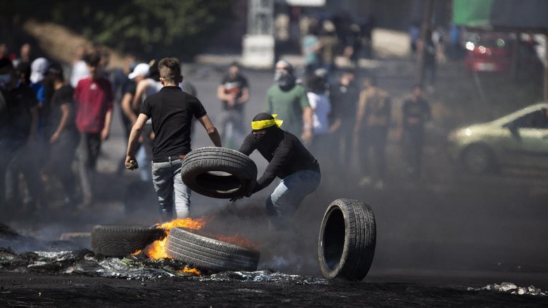 Palestinians clash with Israeli forces at the Hawara checkpoint, south of the West Bank city of Nablus, Tuesday, May 18, 2021. (AP Photo/Majdi Mohammed)