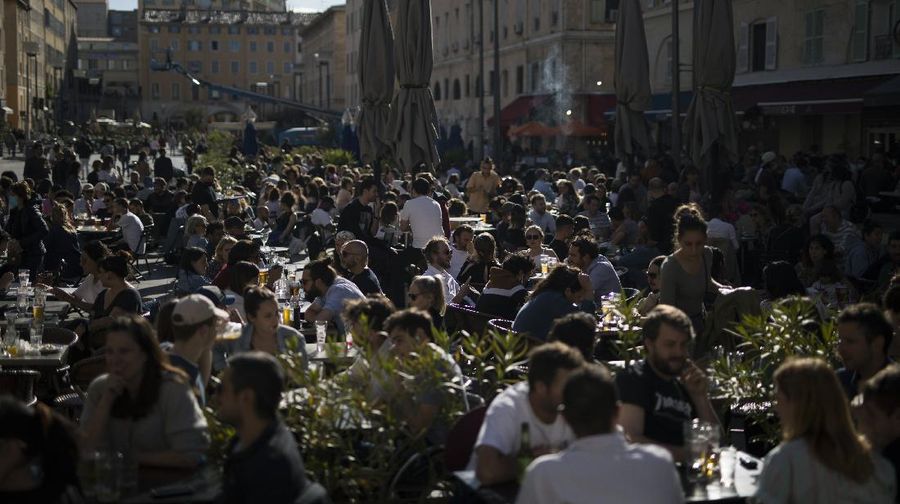 Customers drink beers at cafe terraces in Paris, Wednesday, May, 19, 2021. It's a grand day for the French. Cafe and restaurant terraces reopened Wednesday after a six-month coronavirus shutdown deprived residents of the essence of French 