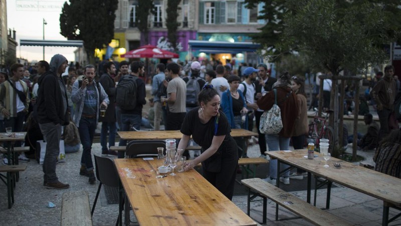 Customers drink beers at cafe terraces in Paris, Wednesday, May, 19, 2021. It's a grand day for the French. Cafe and restaurant terraces reopened Wednesday after a six-month coronavirus shutdown deprived residents of the essence of French 