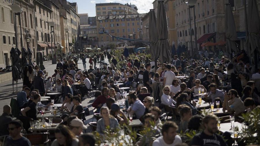 Customers drink beers at cafe terraces in Paris, Wednesday, May, 19, 2021. It's a grand day for the French. Cafe and restaurant terraces reopened Wednesday after a six-month coronavirus shutdown deprived residents of the essence of French 