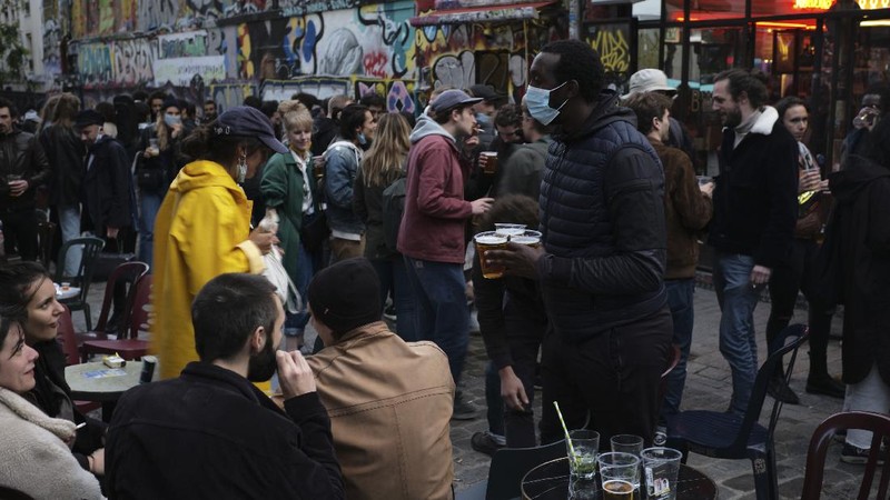Customers drink beers at cafe terraces in Paris, Wednesday, May, 19, 2021. It's a grand day for the French. Cafe and restaurant terraces reopened Wednesday after a six-month coronavirus shutdown deprived residents of the essence of French 