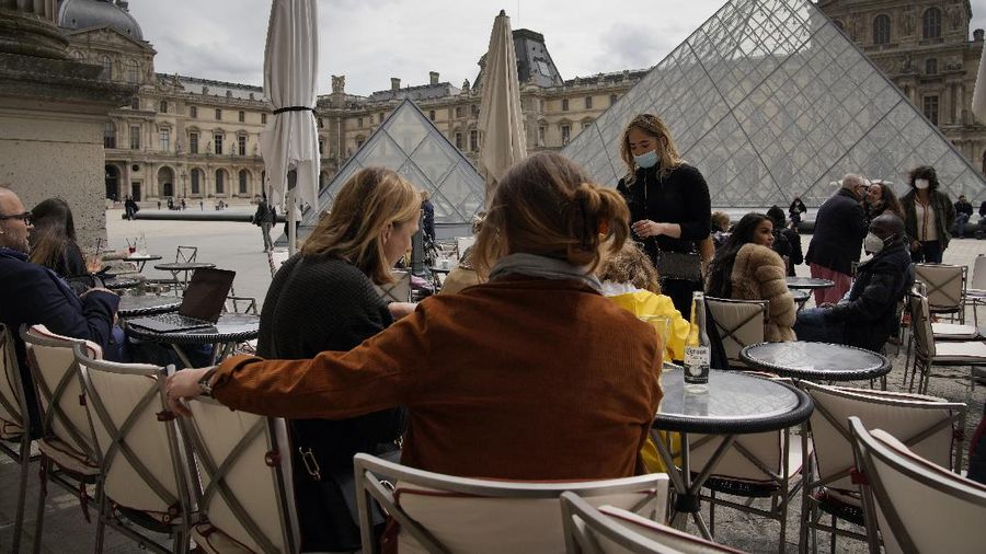 Customers drink beers at cafe terraces in Paris, Wednesday, May, 19, 2021. It's a grand day for the French. Cafe and restaurant terraces reopened Wednesday after a six-month coronavirus shutdown deprived residents of the essence of French 