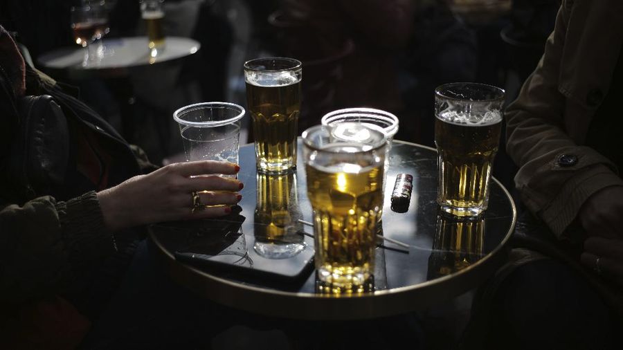 Customers drink beers at a cafe terrace in Paris, Wednesday, May, 19, 2021. It's a grand day for the French. Cafe and restaurant terraces reopened Wednesday after a six-month coronavirus shutdown deprived residents of the essence of French