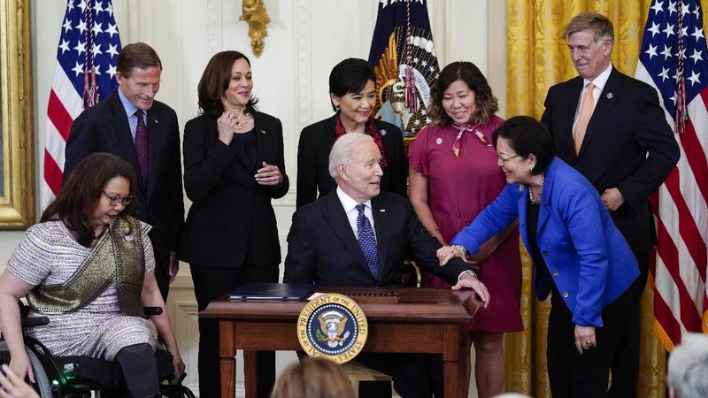 President Joe Biden signs the COVID-19 Hate Crimes Act, in the East Room of the White House, Thursday, May 20, 2021, in Washington. (AP Photo/Evan Vucci)