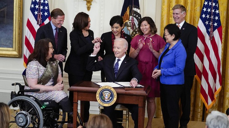President Joe Biden signs the COVID-19 Hate Crimes Act, in the East Room of the White House, Thursday, May 20, 2021, in Washington. (AP Photo/Evan Vucci)