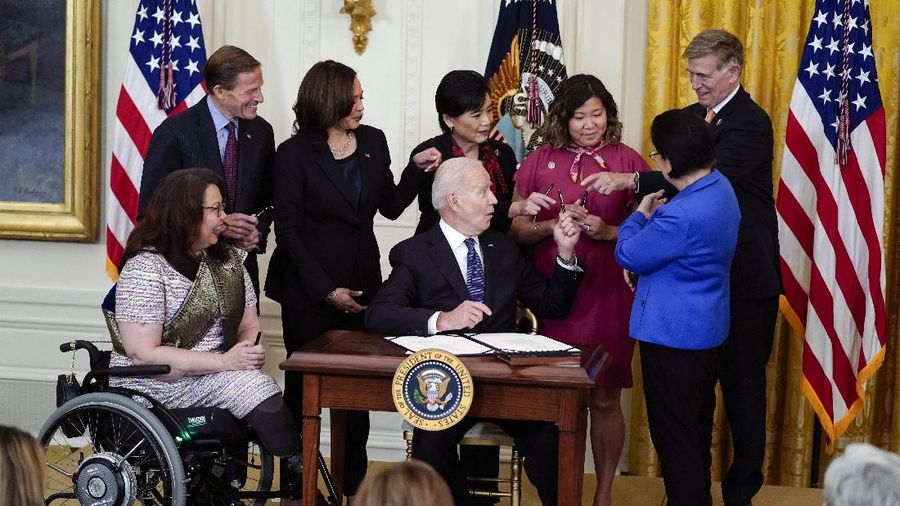 President Joe Biden signs the COVID-19 Hate Crimes Act, in the East Room of the White House, Thursday, May 20, 2021, in Washington. (AP Photo/Evan Vucci)