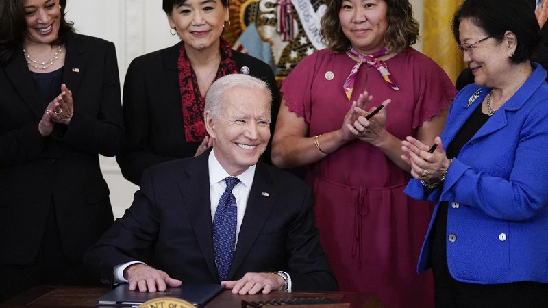 President Joe Biden signs the COVID-19 Hate Crimes Act, in the East Room of the White House, Thursday, May 20, 2021, in Washington. (AP Photo/Evan Vucci)
