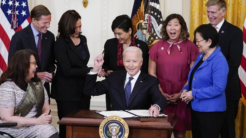 President Joe Biden signs the COVID-19 Hate Crimes Act, in the East Room of the White House, Thursday, May 20, 2021, in Washington. (AP Photo/Evan Vucci)