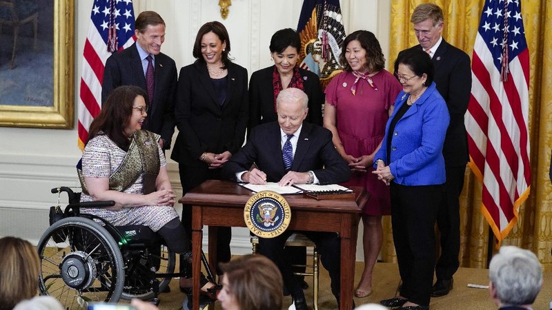 President Joe Biden signs the COVID-19 Hate Crimes Act, in the East Room of the White House, Thursday, May 20, 2021, in Washington. (AP Photo/Evan Vucci)