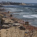 People enjoy the beach front in Tel Aviv, Israel, Saturday, May 22, 2021. A cease-fire took effect early Friday after 11 days of heavy fighting between Israel and Gaza's militant Hamas rulers that was ignited by protests and clashes in Jerusalem. (AP
