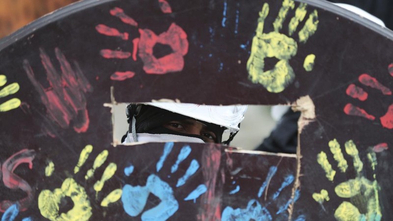 Protesters who call themselves the front line hold homemade shields during an anti-government protest in Bogota, Colombia, Friday, May 28, 2021. Colombians have taken to the streets for weeks across the country after the government proposed tax increases on public services, fuel, wages and pensions. (AP Photo/Fernando Vergara)