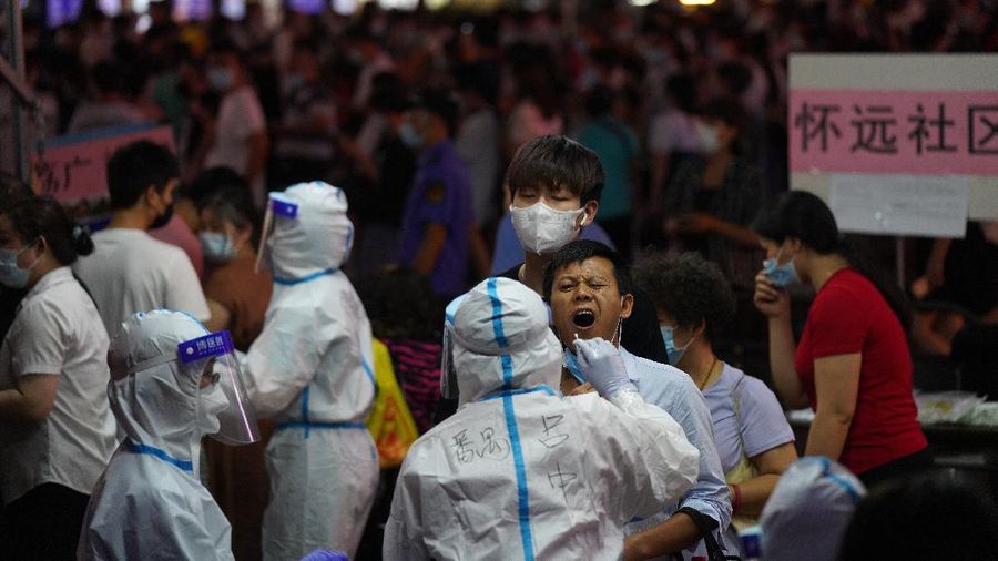 A resident gets tested for coronavirus in the Liwan District in Guangzhou in southern China's Guangdong province on Wednesday May 26, 2021. The southern Chinese city of Guangzhou shut down a neighborhood and ordered its residents to stay home Saturday, May 29, for door-to-door coronavirus testing following an upsurge in infections that has rattled authorities.(AP Photo)